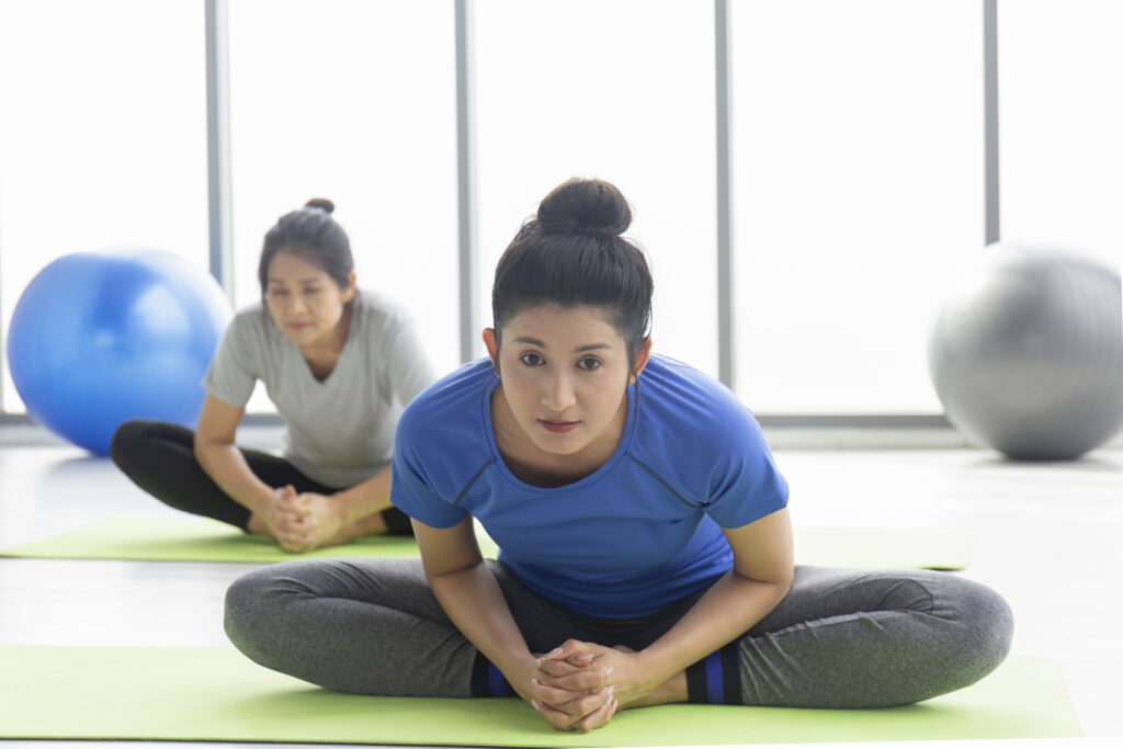 Two women practice in a weight loss program