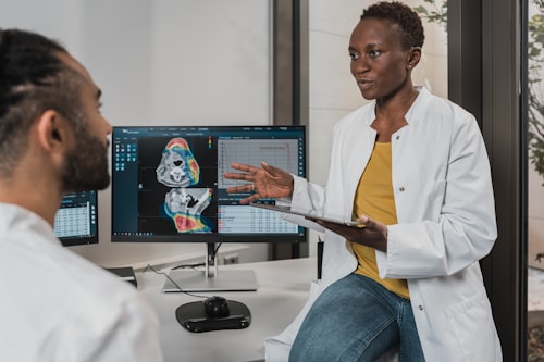 Provider reviewing advanced imaging technology with a colleague at J9 Clinic in Houston