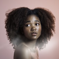 Woman with natural curly hair after hair restoration care at J9 Clinic in Houston